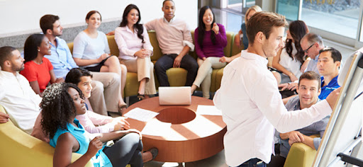 Businessman Making Presentation To Office Colleagues In Smart/Casual Dresswear